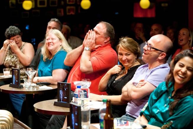 Audience members crack up laughing as comedians heckle front-row guests at Brad Garrett's Comedy Club in Las Vegas Tuesday, April 30, 2013.